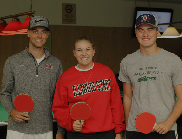 Siblings playing ping pong in the Bowling and Billiards center